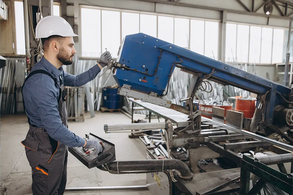 worker operating a band saw