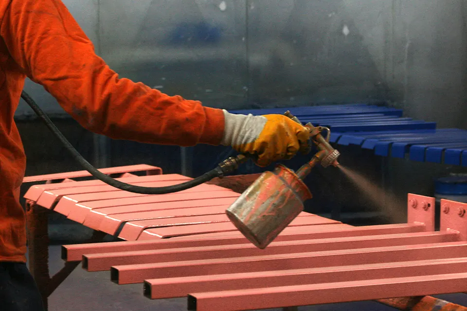 spraying primer on tube brackets