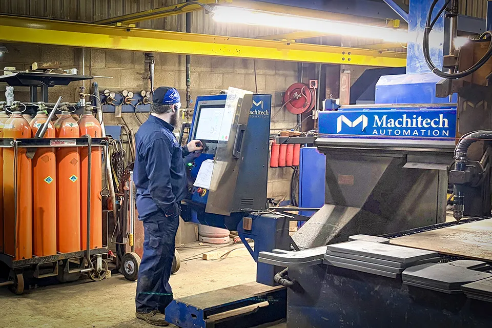 technician working cnc cutting machine