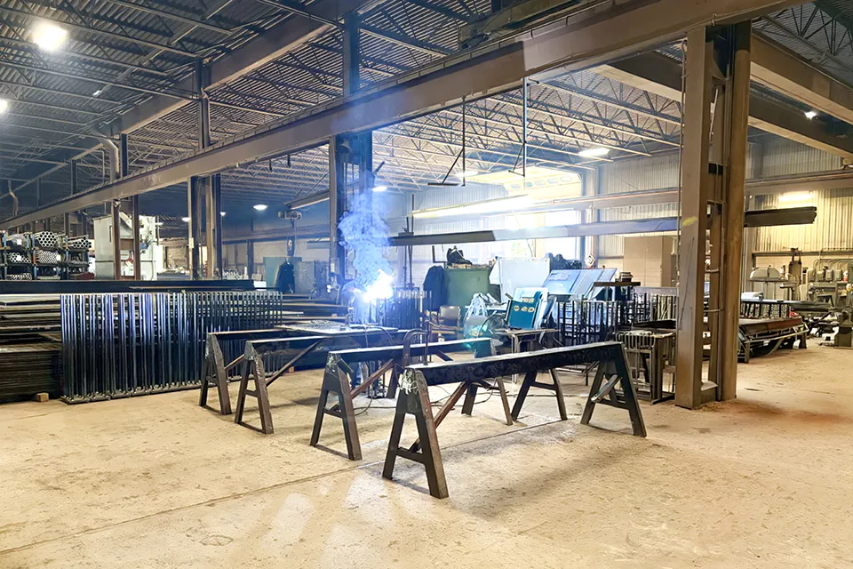 person welding in open shop area